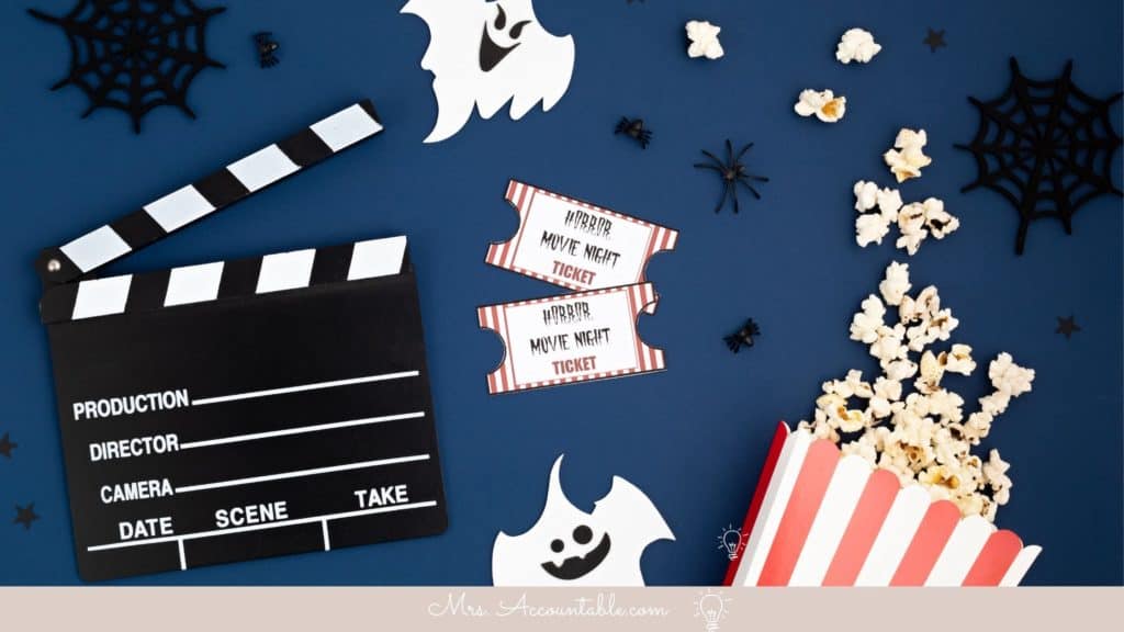 MOVIE CLAPBOARD WITH POPCORN, MOVIE TICKETS, GHOSTS, AND SPIDERS