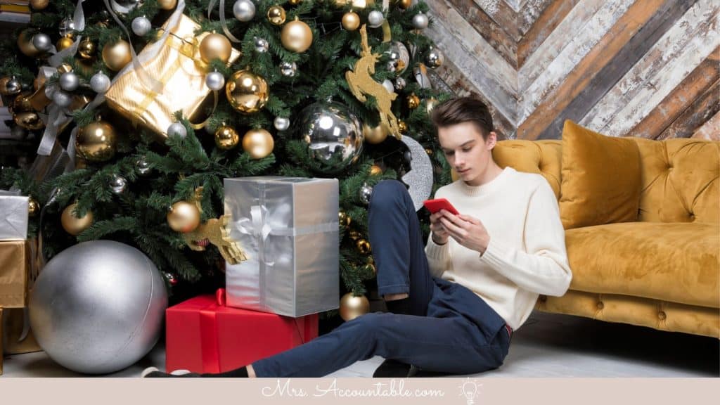 CHRISTMAS GIFTS FOR TEEN BOYS INCLUDING BOY WITH CELL PHONE LEANING ON A COUCH