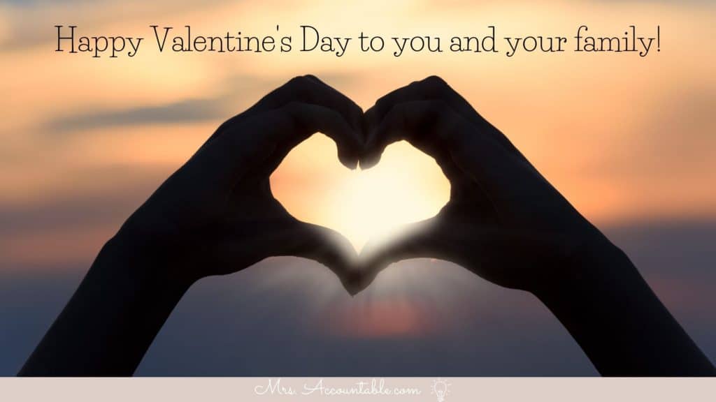 IMAGE OF HANDS IN THE SHAPE OF A HEART IN FRONT OF A SUNSET WITH TEXT OF HAPPY VALENTINES DAY TO YOU AND YOUR FAMILY.